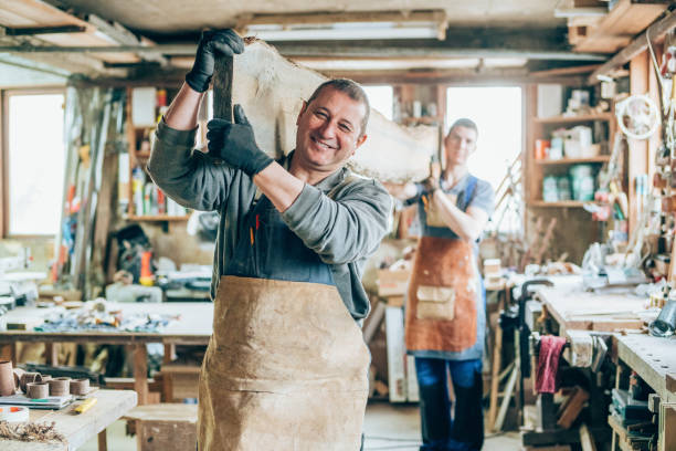 istock Carpenters carrying a wood plank 1143915578