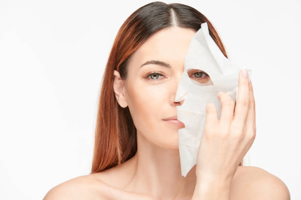 istock Woman peeling mask off 1143915714