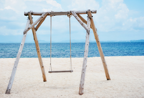 Wooden swing on the beach and Blue Ocean Sea Water Landscape Seascape.,copy space.,Thailand