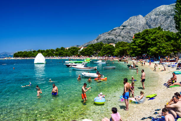 Promajna, Croatia - July 11, 2018: Vacationers on the public beach of the town of Promajna.