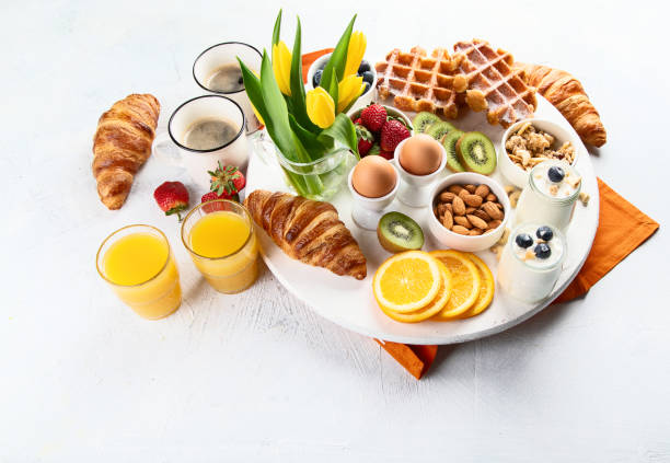 istock Breakfast table with eggs, berries, yogurt,waffle and croissant 1143924075