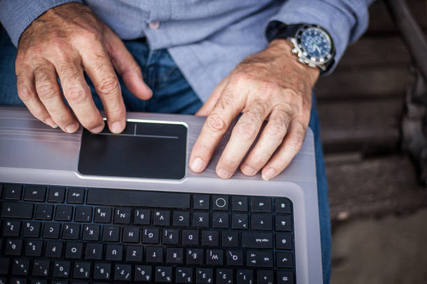 istock Senior hand on laptop 1143925520