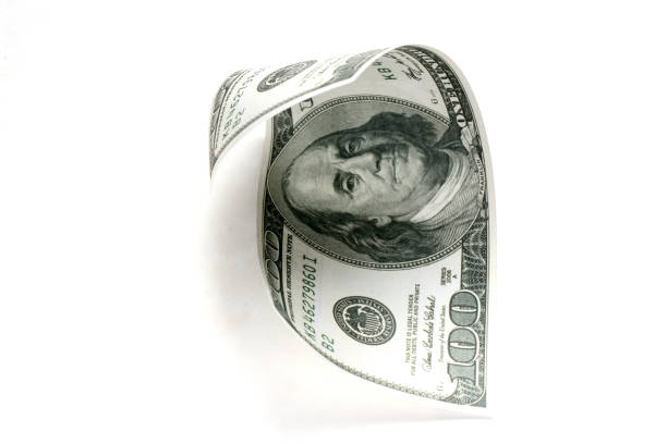 istock Rolled one hundred dollar money on white background 1143928275
