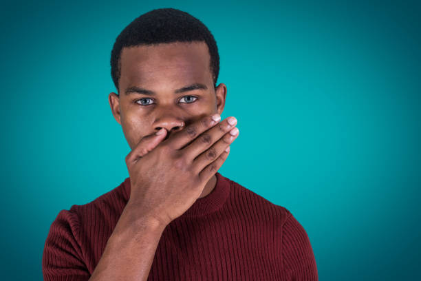 istock Silent black guy covering mouth 1143929568