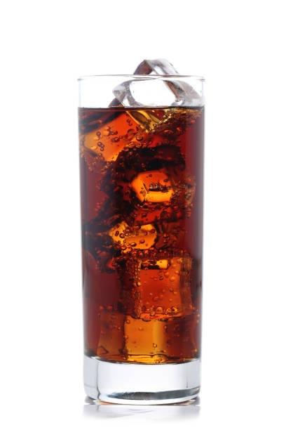 Cold cola in a clear glass with ice cubes. Close up. White background. 