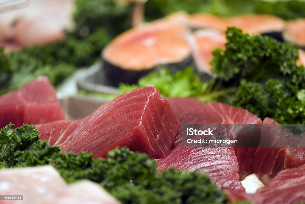 Fresh tuna steaks in the fish market  Fish Vendor Stock Photo