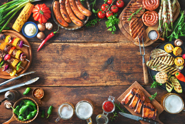 istock Grilled meat and vegetables on rustic wooden table 1143931761