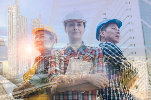 istock Double exposure engineering and construction concept. Industrial engineer wear safety helmet engineering standing with arms crossed on building outside. Engineering tools and construction concept. 1143932861