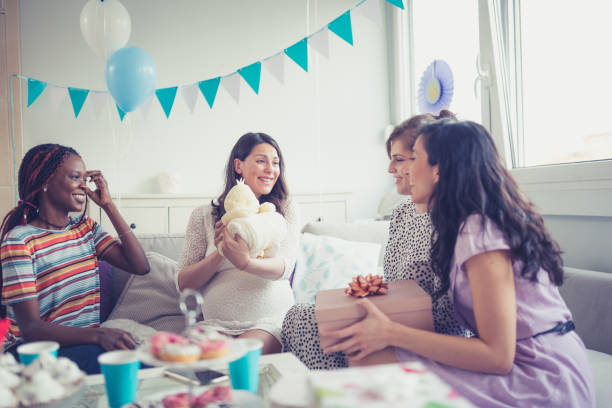 Baby showers party Four girlfriends on baby shower party baby shower stock pictures, royalty-free photos & images