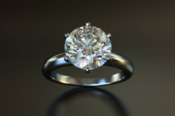 istock Solitaire diamond engagement ring on gray brown glossy background 1143934877
