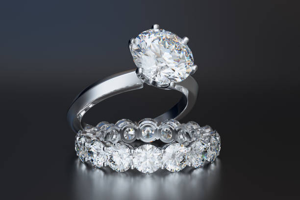 istock Solitaire diamond engagement ring, eternity wedding ring, on gray glossy background 1143934878