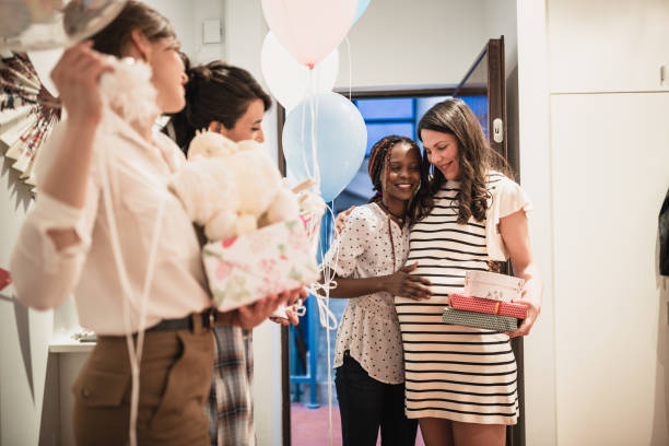 Baby showers party Gussets entering the party. Their pregnant girlfriend opening the doors and welcome them baby shower stock pictures, royalty-free photos & images