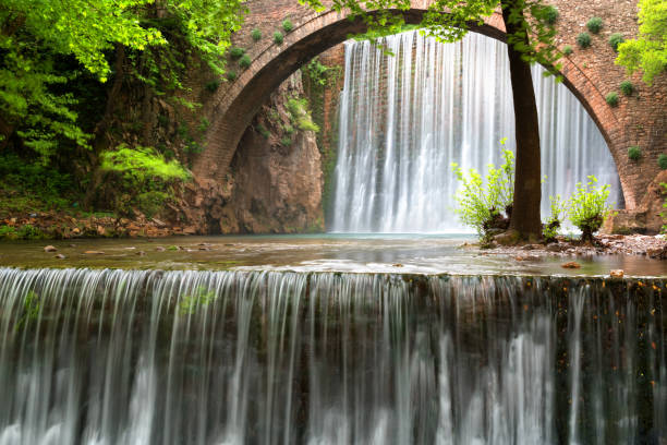 istock Stunning spring landscape.Paleokarya, old, stone, arched bridge, between two waterfalls. Trikala prefecture, Thessaly, Greece 1143936952