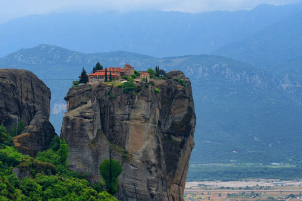 istock Monastery Holy Trinity, Meteora, Greece. UNESCO world heritage Site. Epic spring landscape with temple at the edge of cliff at dramatic sky background. 1143936980