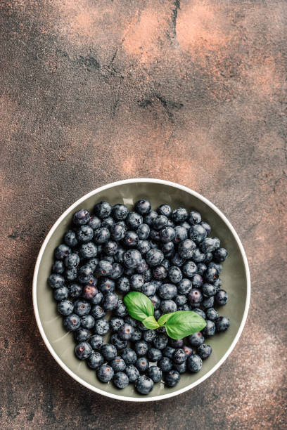 istock Fresh blueberries in a cup on white background 1143937045