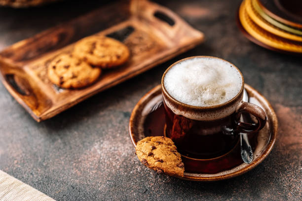 istock Cappuccino in coffee cup on dark rustic background 1143938753
