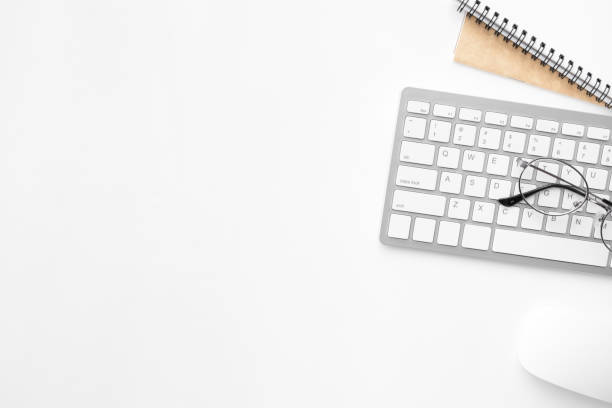 istock White office desk table with computer mouse, keyboard and supplies. Top view with copy space, flat lay. 1143939044