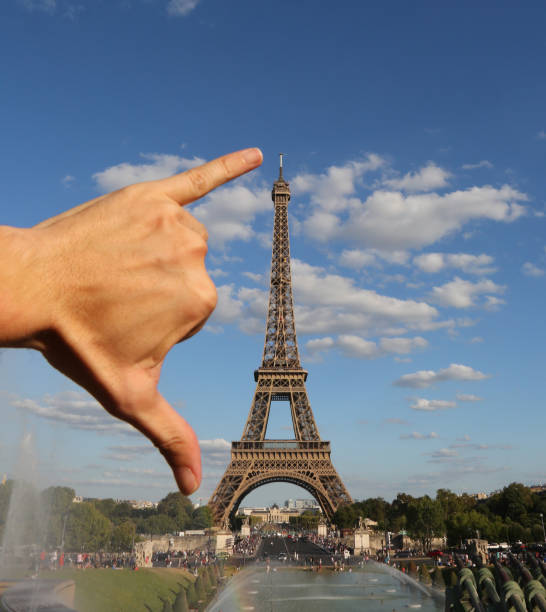 istock hand of man and measures the Eiffel Tower 1143941491