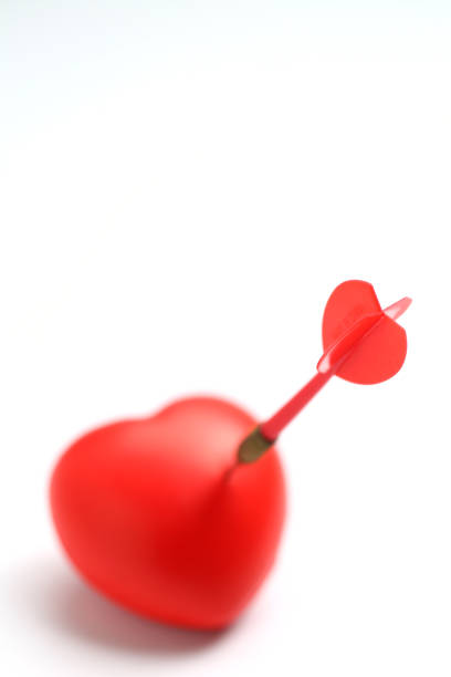 istock Red Dart Stuck in Heart Isolated on White Background. 1143943053