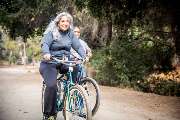istock Senior Mexican Couple Riding Bikes 1143943246