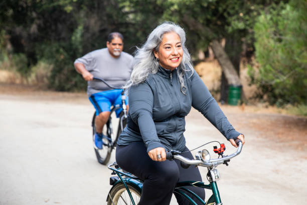 Senior Mexican Couple Riding Bikes Attractive Mexican Couple Biking fat mexican man pictures stock pictures, royalty-free photos & images