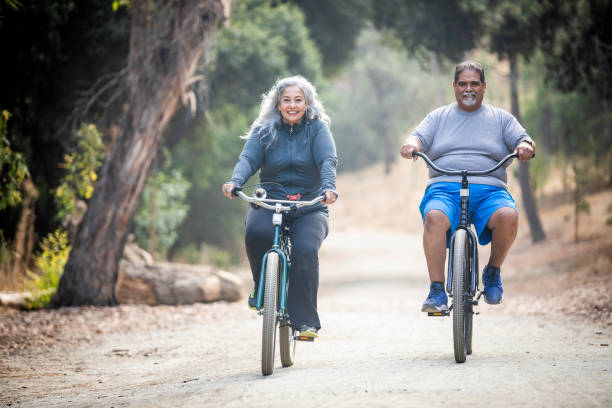 Senior Mexican Couple Riding Bikes Attractive Mexican Couple Biking fat mexican man pictures stock pictures, royalty-free photos & images