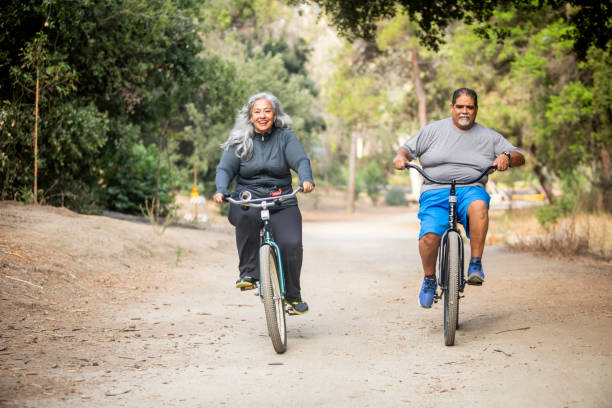 istock Senior Mexican Couple Riding Bikes 1143943449