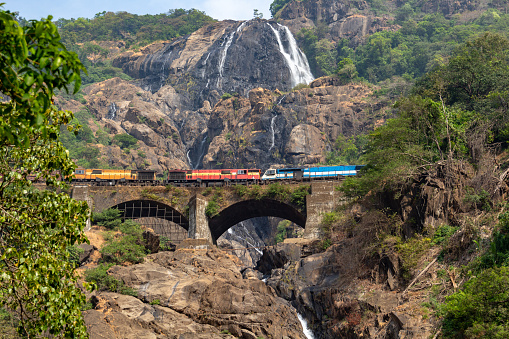 Train on the railway bridge on the background of the Dudhsagar Falls