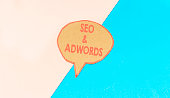 seo and adwords speech bubble isolated on pink and blue background
