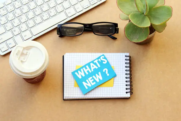 what's new ? concept, desktop: notebook, paper and disposable cup coffee, eyeglasses, keyboard, pot plant