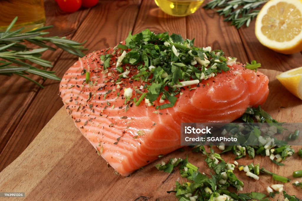 Fresh raw Salmon Fillet on cutting board Cherry Tomato Stock Photo