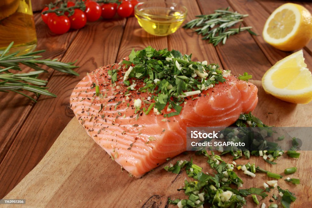 Fresh raw Salmon Fillet on cutting board Cherry Tomato Stock Photo