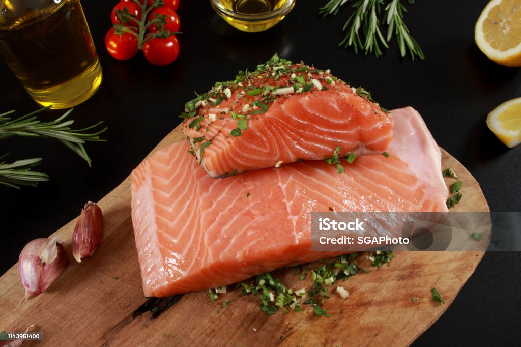 Fresh raw Salmon Fillet on cutting board Cherry Tomato Stock Photo