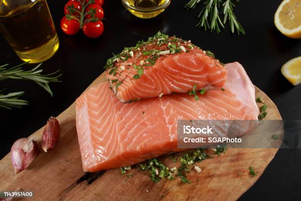 Fresh Raw Salmon Fillet On Cutting Board Stock Photo - Download Image Now - Cherry Tomato, Cilantro, Cooking Oil