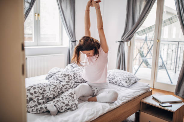 istock Young woman is stretching in her bed 1143951472