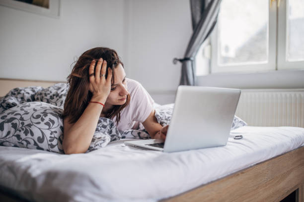 istock Woman is using laptop in her bed 1143952094