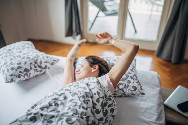 istock Sleepy young woman stretching 1143952127