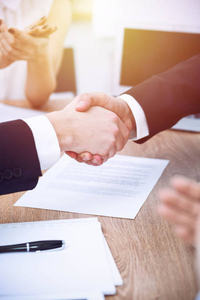 business people shaking hands at meeting or negotiation in the office. handshake concept. partners are satisfied because signing contract. - team human hand cheerful close up imagens e fotografias de stock