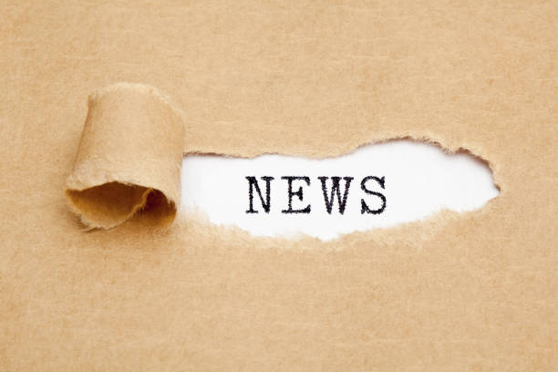 Text Big News appearing behind ripped brown paper.