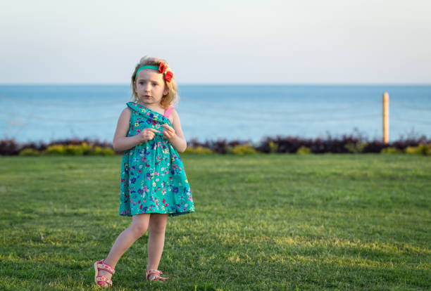 A little girl stands on the lawn of a tourist hotel in Egypt. Sharm El Sheikh.