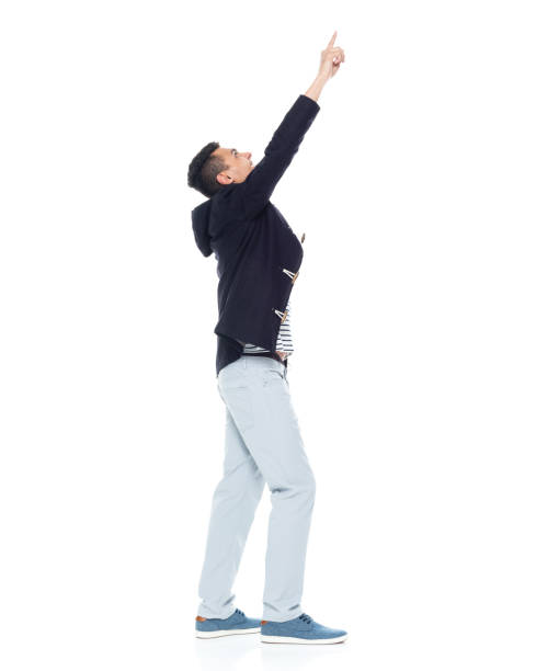 istock Handsome African American male standing on white background - pointing up 1143961632