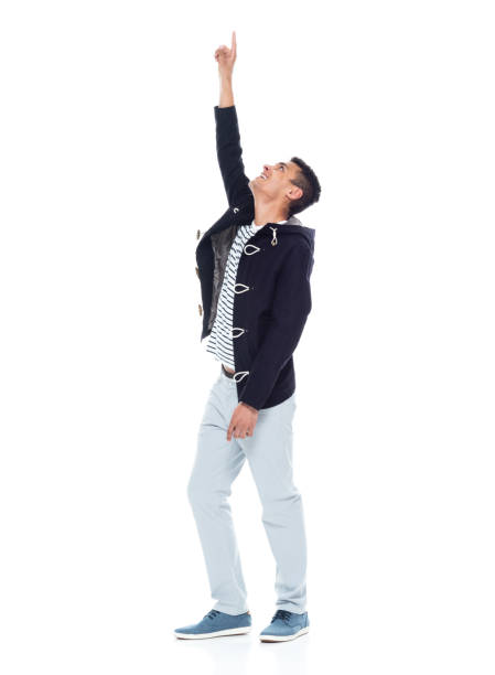 istock Handsome African American male standing on white background - pointing up 1143961665