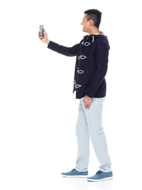istock Handsome African American male standing on white background - taking a selfie 1143961744