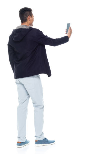 istock Handsome African American male standing on white background - taking a selfie 1143961796