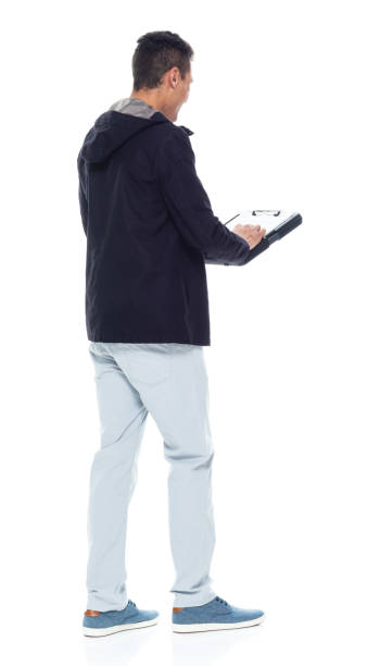 istock Handsome African American male standing on white background - using a clipboard 1143961868