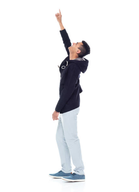 istock Handsome African American male standing on white background - pointing up 1143961905
