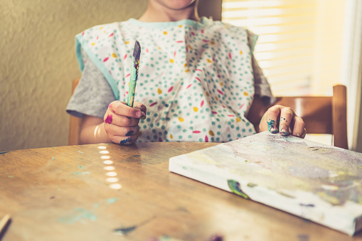 Little Toddler Boy Colorfully Drawing with a Paintbrush