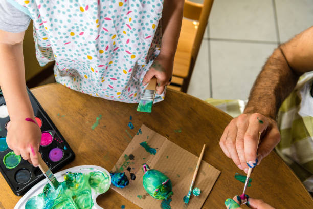 istock Father and son painting together 1143962215