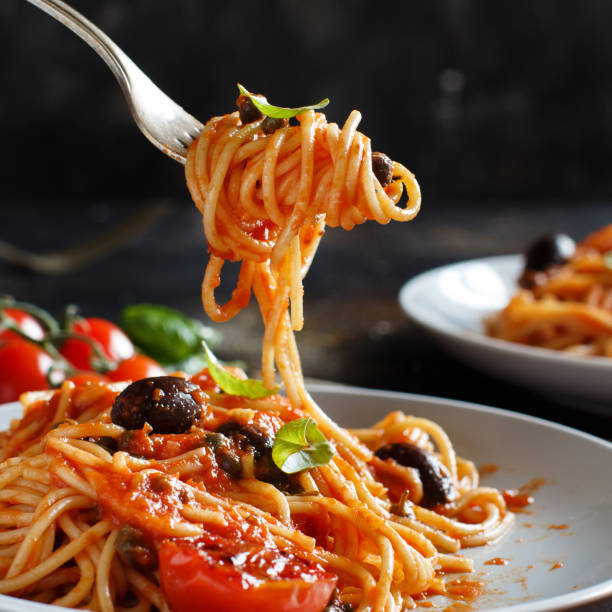 istock Spaghetti with tomato sauce olives and capers 1143963388