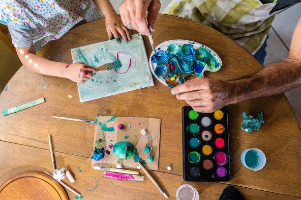 istock Father and son painting together 1143963422